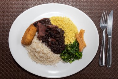Delicious feijoada plate. Brazilian typical cuisine made with black beans and pork.