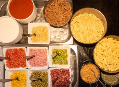 Pasta self service buffet with a variety of ingredients to be chosen