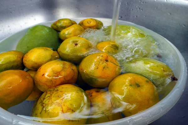 The fruits sinking and washing in water
