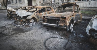 Burnt and decayed cars after shelling by rocket artillery in a residential area in Ukraine during the military escalation of hostilities and armed military aggression