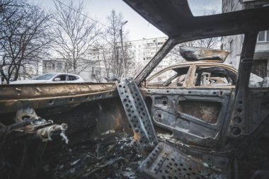 Burnt and melted car inside after rocket artillery shelling in a residential area in Ukraine during the military escalation of hostilities and military aggression