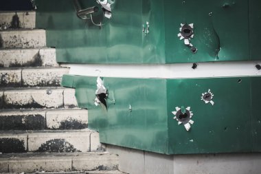 Holes from fragments from artillery shelling in the cities of Ukraine during armed hostilities and aggression