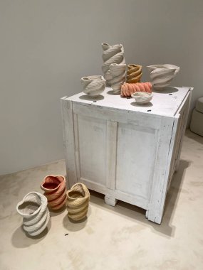 a view of ceramic vases and white box