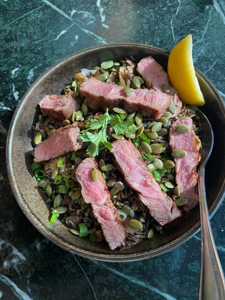 Close-up of a plate with beef and garnish
