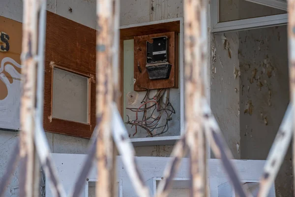 Electrical panel, a selective focus broken electrical panel behind the railing in the abandoned city. Varosha in Famagusta North Cyprus.