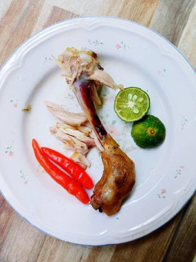 close-up photo of leftover chicken bones on a white plate