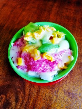 Es Campur or Sop Buah or mixed fruit ice dessert, popular Indonesian fruit ice with grass jelly, syrup and milk. Selected focus.