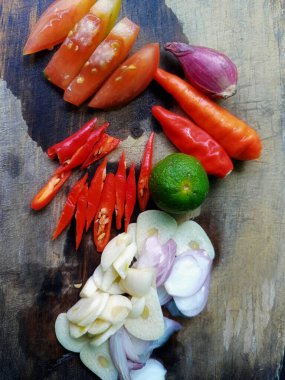 ingredients in the kitchen to make fresh sauce, tomatoes, chilies, onions and limes