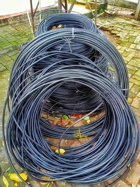 pile of PVC cables lying on the brick floor,usually there will be a cable network installation project for electricity or internet nerworks