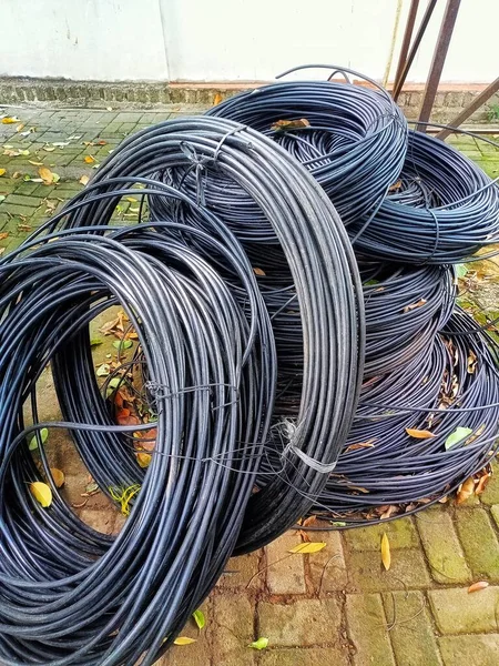 pile of PVC cables lying on the brick floor,usually there will be a cable network installation project for electricity or internet nerworks