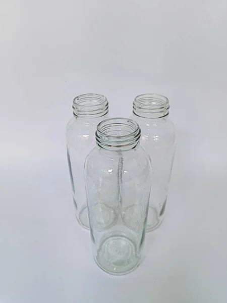 Collection of 3 empty bottles on white background, high angle view