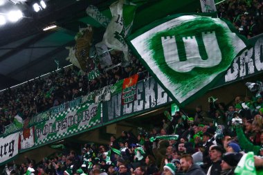 Wolfsburg, Germany, December 12, 2019:supporters of Bundesliga with VfL Wolfsburg flag during the UEFA Europa League match