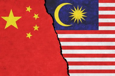 China and Malaysia painted flags on a wall with a crack. China and Malaysia conflict. Malaysia and China flags together. China vs Malaysia