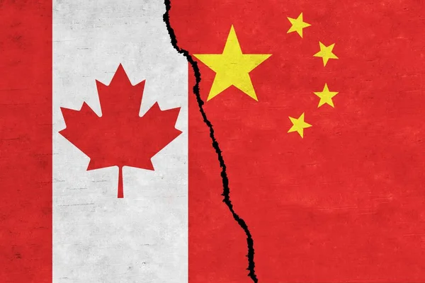 China and Canada painted flags on a wall with a crack. China and Canada relations