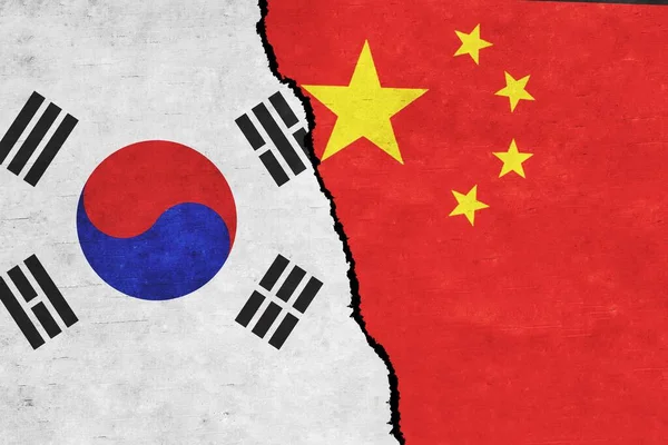 China and South Korea painted flags on a wall with a crack. China and South Korea relations