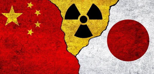 Flags of China, Japan and radiation symbol together. China and Japan Nuclear deal, threat, agreement, tensions concept