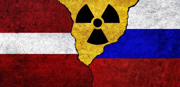 Flags of Latvia, Russia and radiation symbol together. Russia and Latvia Nuclear deal, threat, agreement, tensions concept