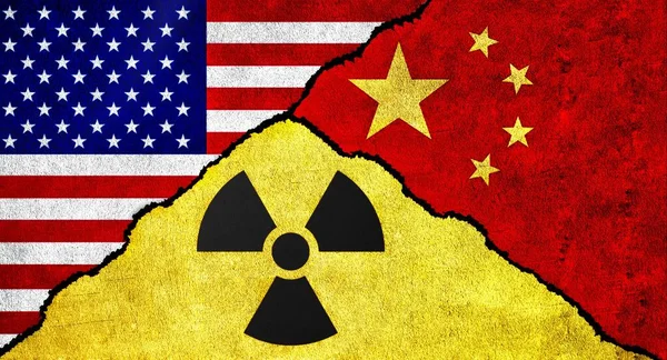 Flags of United States of America (USA), China and Nuclear symbol together on a textured wall