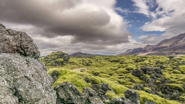 アイスランドの北部の山々に沿って広がる溶岩原は 岩の後ろのすべて — ストック写真
