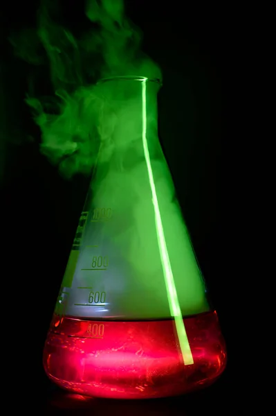 Strong chemical reaction with a lot smoke and vapors inside Erlenmeyer flask. School chemical experiment. High quality photo