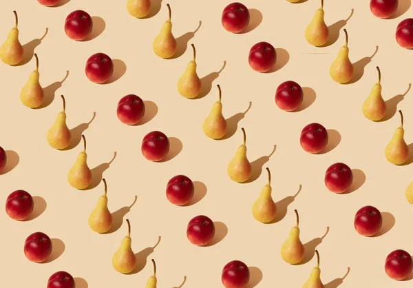 Fresh yellow pear and peach pattern against pastel beige background. Minimal summer fruit layout.