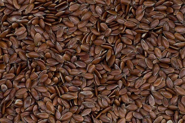 High angle full-frame photo of wholegrain linseed grains making pattern for background, wallpaper