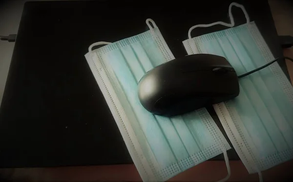 computer mouse and surgical masks in covid time