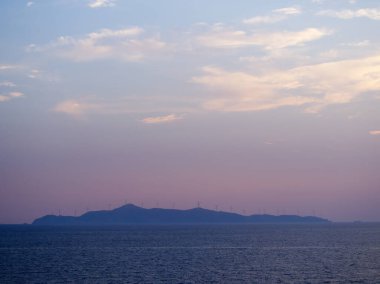 Günbatımında rüzgar türbinleri, Agios Georgios, Cyclades, Yunanistan 