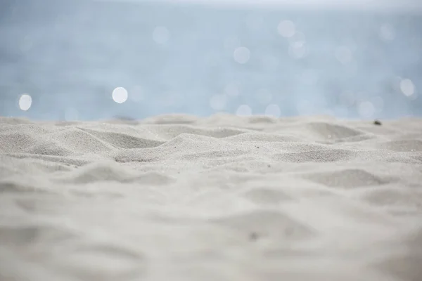 Beach Sand and Sparkling Ocean Background