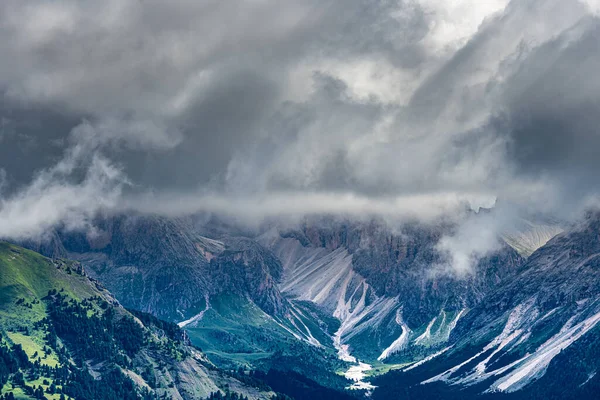 Moody sky over meadows in the Dolomites, Trentino Italy. Summer 2021. High quality photo with telephoto lens.