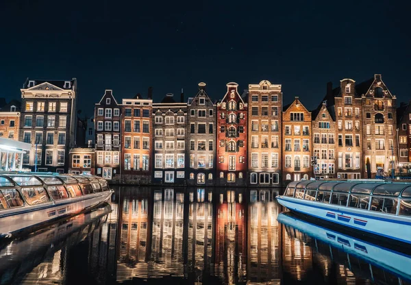 Dancing Houses Damrak Amsterdam during the night Netherlands Holland. High quality photo