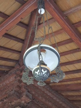 Antique lamp hanging above the ceiling of the house