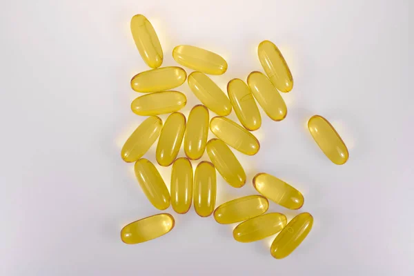 Yellow Oval Capsules Lie Next Each Other Light Background Pharmacies — Stock Photo, Image