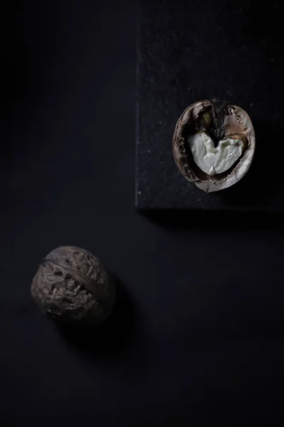 cut walnut tart on a black kitchen cutting board on a black background.for cookbooks with recipes banners labels for different types of products