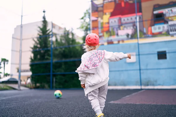 Little Girl Tracksuit Chasing Ball Sports Ground High Quality Photo — Stock Photo, Image