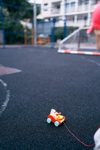 Toy car on a rope in the sports ground. High quality photo