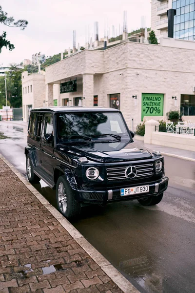 Siyah Mercedes G-Wagen sokakta kaldırımın kenarında duruyor. Yüksek kalite fotoğraf