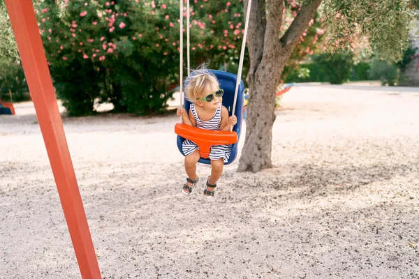 Little Girl Swings Swing Background Flowering Tree Playground High Quality — Stock Photo, Image