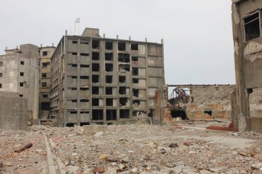 Battleship Island front view of an old broken building. Scary buildings at Hashima Island Japan