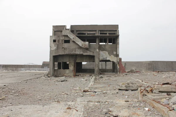 Single building at Hashima Island. Ruins of Battleship Island. Scary building looks like a ghost place.