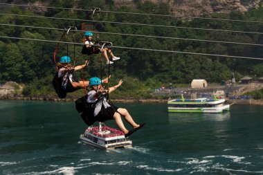 NIAGARA FALLS, ONTARIO, CANADA - AUGUST 9/2021 - Tourists enjoying a zip line adventure in Niagara Falls.