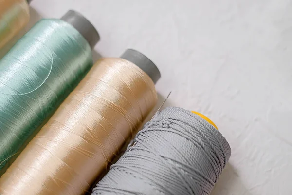 Top view of colorful threads on a bright table.