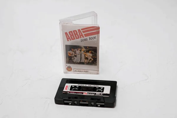 Jakarta, Indonesia - May ,10 2022 : Original cassette tape and song lyrics, Song Book (1973-1982), a legendary performance BLACK LABEL from the band ABBA released by KING'S Records from Indonesia.