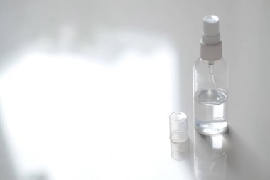 Plastic spray bottle filled with half the disinfectant liquid and empty space for text