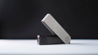 A crypto hardware wallet isolated on a white underground and black background