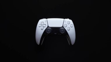 Modern white gamepad isolated on a black background