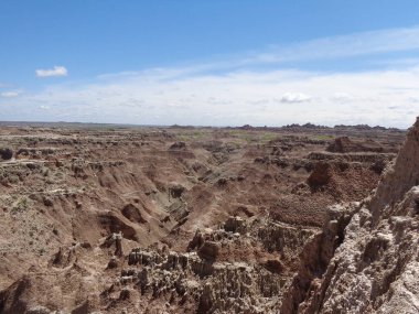 standing on top of the mountains in the badlands of south dakota
