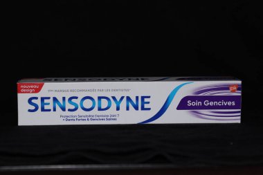 Sensodyne toothpaste illustrated on a black background