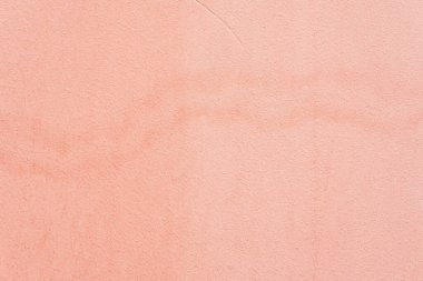 Lekeli, sıva duvarlı. Mercan rengi grunge dokusu. Soyut arkaplan, kopyalama alanı