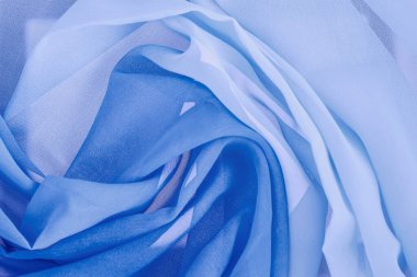 Tekstil dokusu, soyut arkaplan, sarmal dalgalı çizgiler, mavi rengin çeşitli tonları.